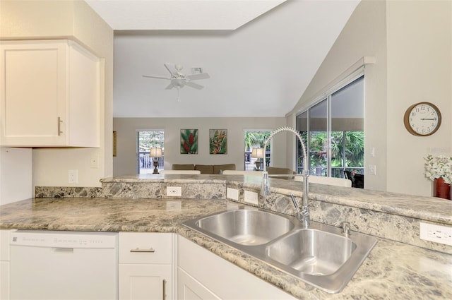 kitchen with white cabinetry, ceiling fan, dishwasher, sink, and lofted ceiling