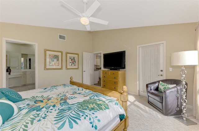 bedroom featuring lofted ceiling, ensuite bathroom, ceiling fan, light colored carpet, and a closet