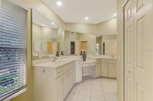 bathroom featuring tile patterned flooring, vanity, and vaulted ceiling