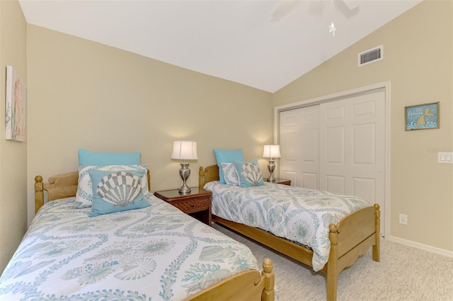 carpeted bedroom with a closet, ceiling fan, and lofted ceiling