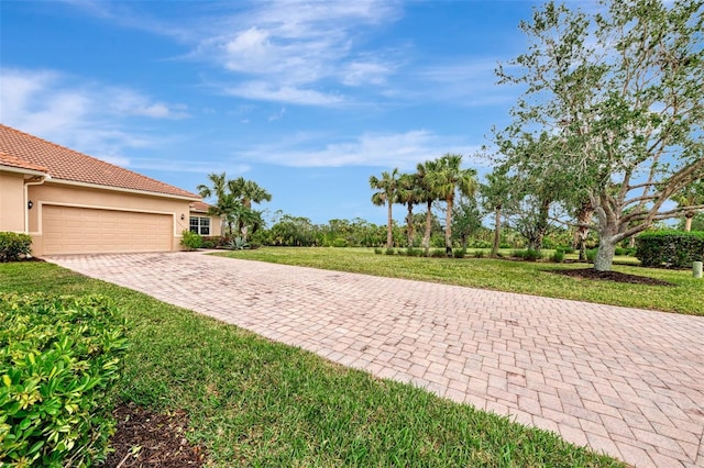 exterior space with a garage and a yard