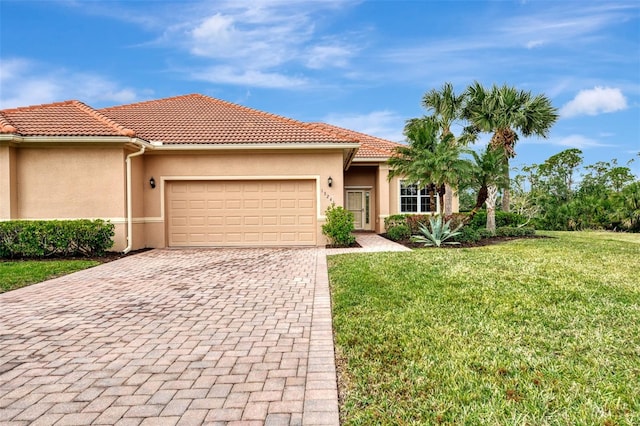 mediterranean / spanish house featuring a front lawn and a garage