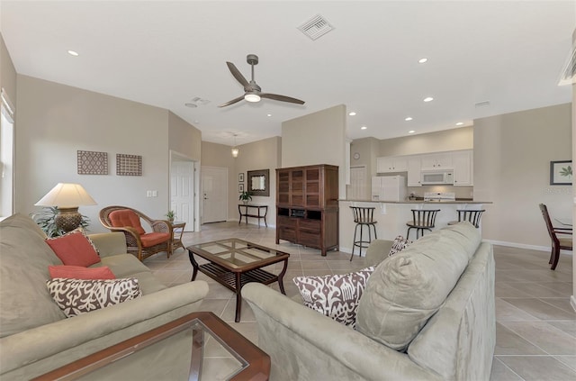 living room with ceiling fan and light tile patterned floors