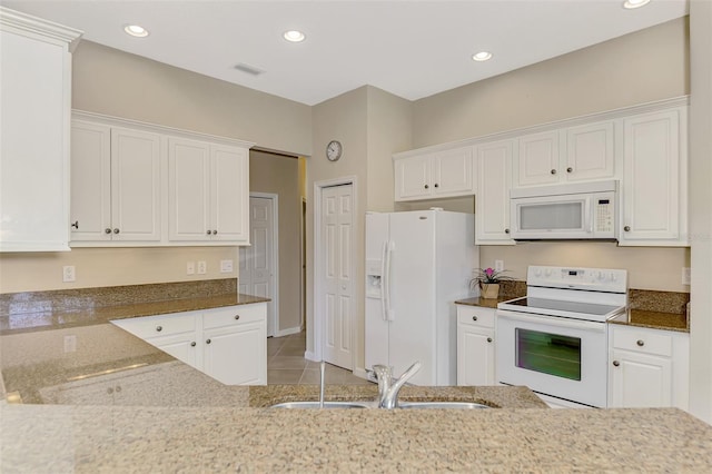 kitchen with white cabinetry, sink, and white appliances