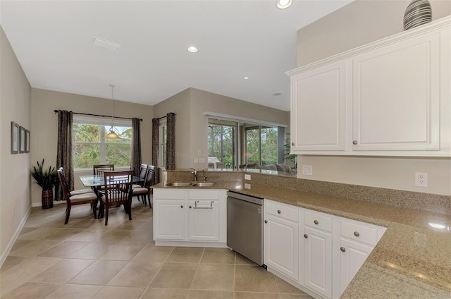 kitchen with stainless steel dishwasher, white cabinets, and light stone countertops