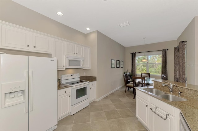 kitchen featuring sink, white cabinets, and white appliances