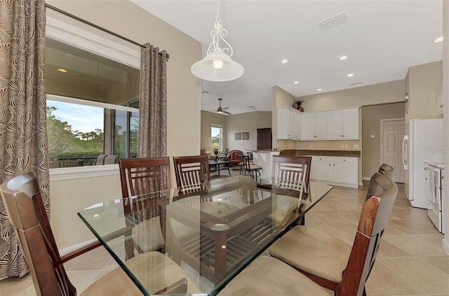 tiled dining area featuring ceiling fan and a wealth of natural light