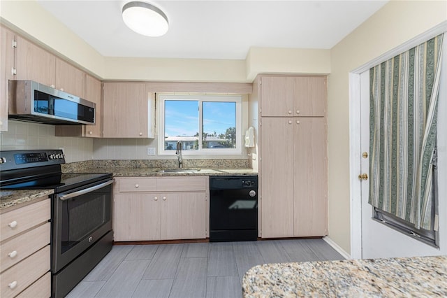 kitchen with tasteful backsplash, light stone countertops, stainless steel appliances, light brown cabinets, and a sink