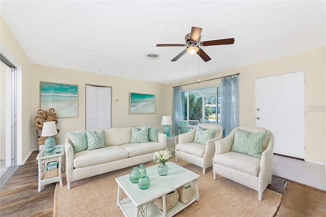 living room with ceiling fan and hardwood / wood-style floors