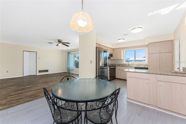 kitchen featuring visible vents, appliances with stainless steel finishes, a wealth of natural light, and light brown cabinetry