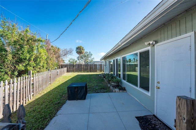 view of yard featuring a patio area and a fenced backyard