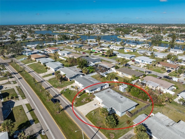 drone / aerial view featuring a water view and a residential view