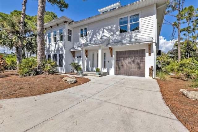 view of front of property with a garage and concrete driveway