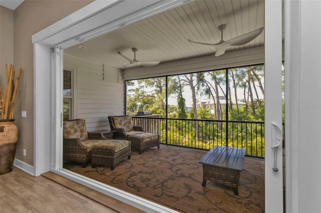 sunroom featuring ceiling fan