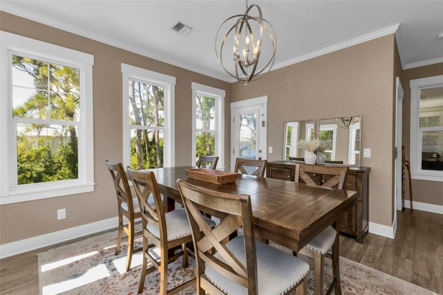 dining space featuring crown molding, baseboards, visible vents, and a healthy amount of sunlight