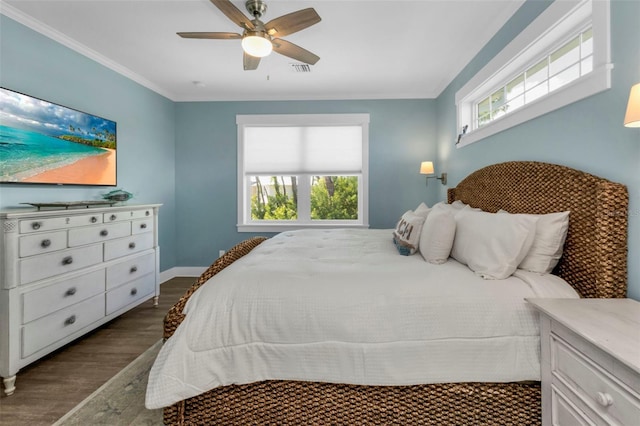 bedroom featuring baseboards, a ceiling fan, crown molding, and wood finished floors