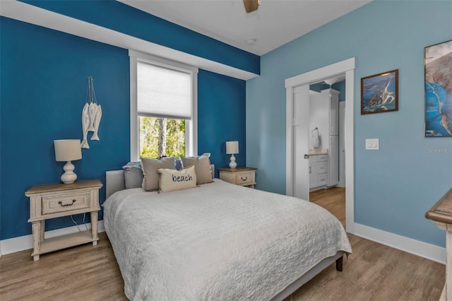 bedroom featuring a ceiling fan, baseboards, and wood finished floors