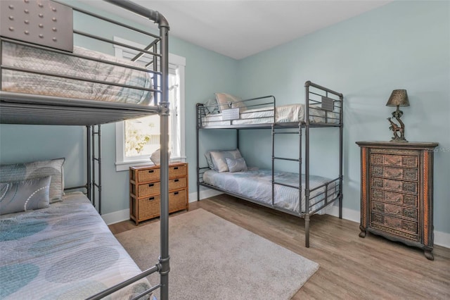 bedroom featuring wood finished floors and baseboards