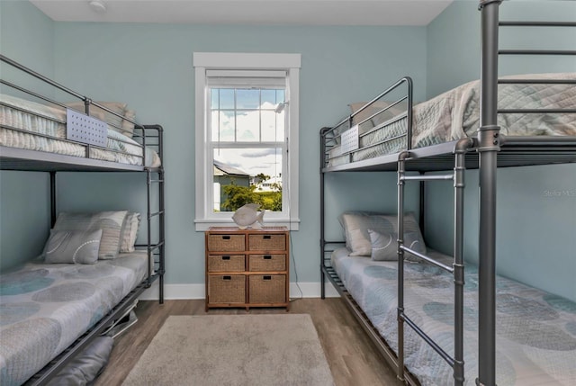 bedroom with baseboards and wood finished floors