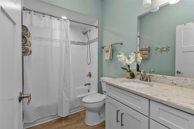 full bathroom with toilet, shower / tub combo, wood finished floors, and vanity