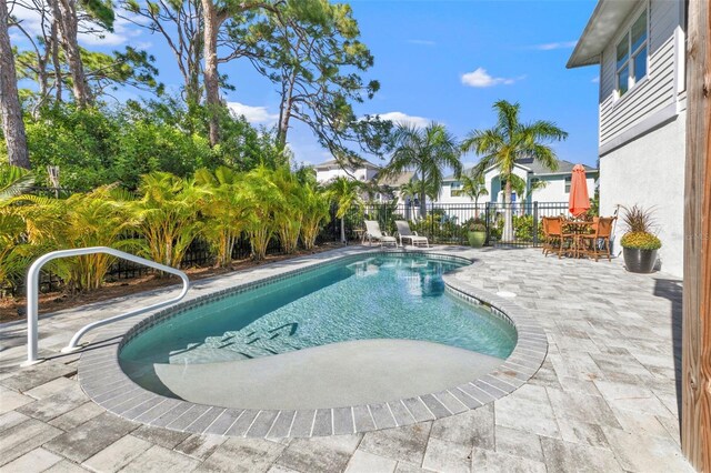 view of pool with a fenced in pool, fence, and a patio