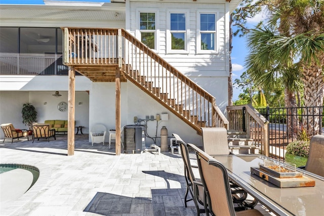 view of patio / terrace featuring stairs and fence