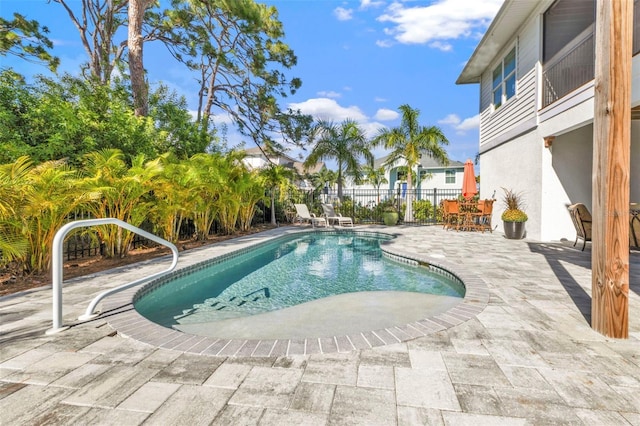 view of pool featuring a patio area, fence, and a fenced in pool