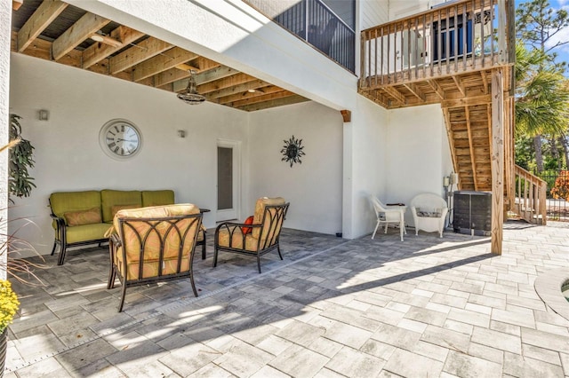 view of patio / terrace featuring an outdoor hangout area, stairway, cooling unit, and a balcony