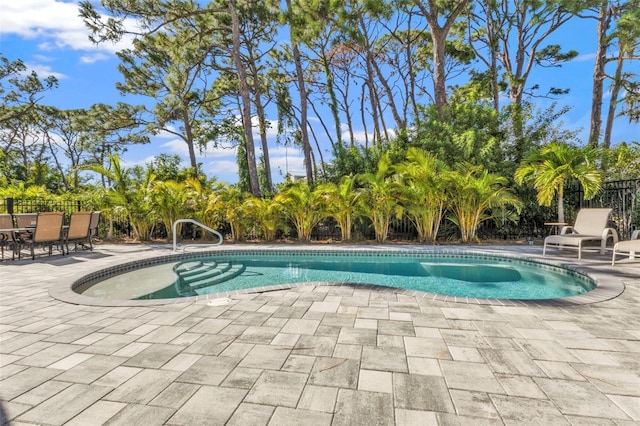 view of pool with a fenced in pool, a patio, and fence