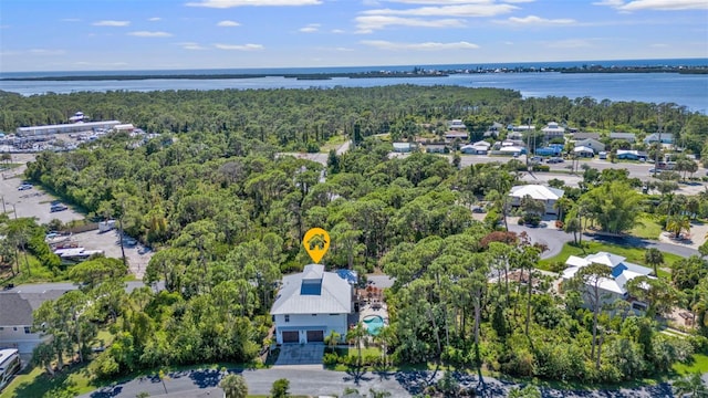 drone / aerial view with a water view and a wooded view