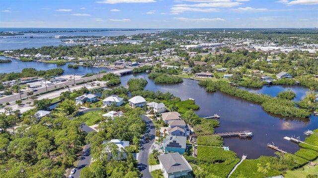 drone / aerial view with a water view and a residential view