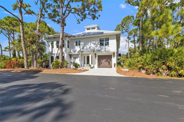 view of front facade featuring concrete driveway and an attached garage