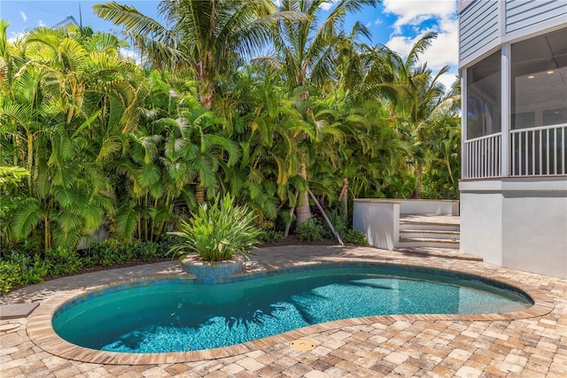 view of pool with a sunroom