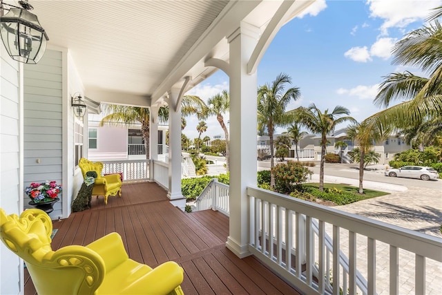 wooden deck with a residential view and covered porch