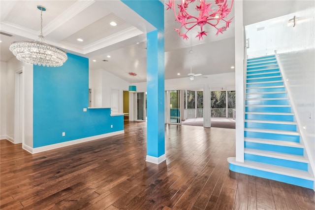 unfurnished living room with crown molding, wood-type flooring, and ceiling fan with notable chandelier