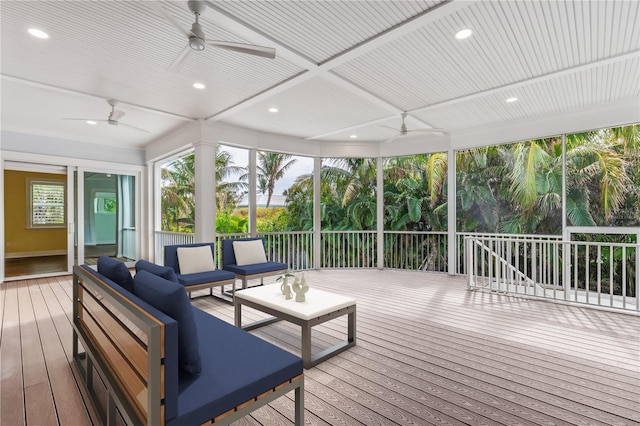 wooden deck featuring outdoor lounge area and ceiling fan