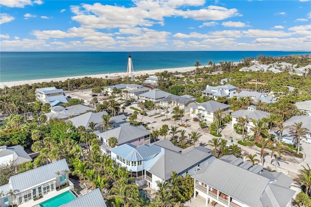 drone / aerial view featuring a view of the beach and a water view