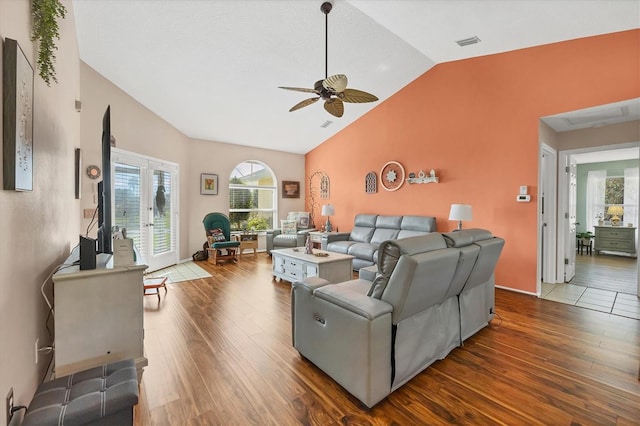 living room featuring french doors, ceiling fan, wood-type flooring, and vaulted ceiling