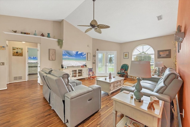 living room featuring light hardwood / wood-style floors, high vaulted ceiling, and ceiling fan