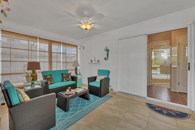 interior space featuring crown molding, ceiling fan, and tile patterned flooring