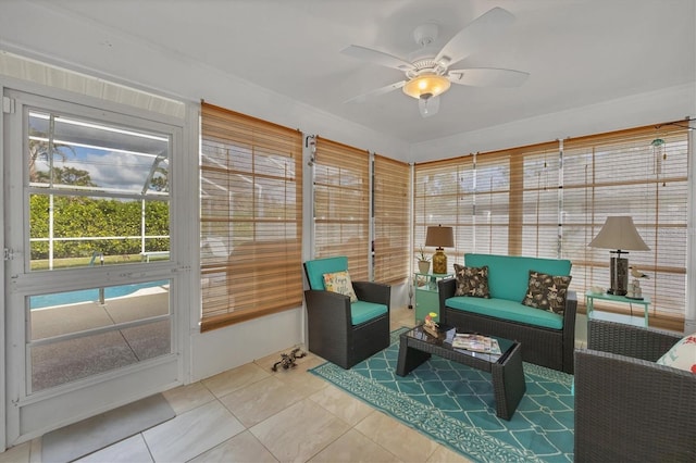 sunroom featuring ceiling fan