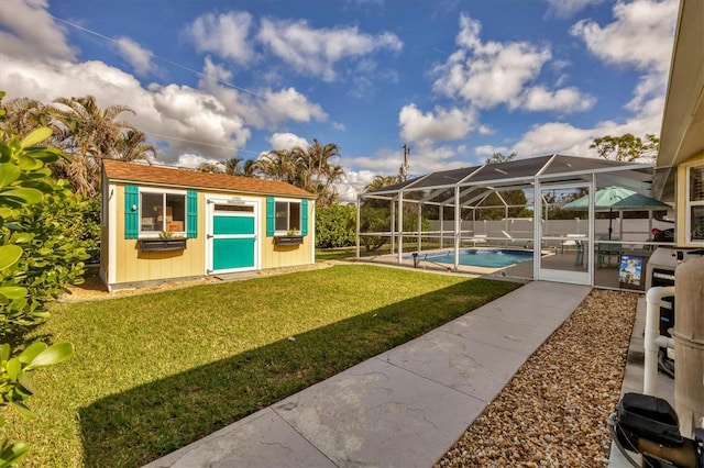 view of yard with a fenced in pool, a lanai, and a storage shed