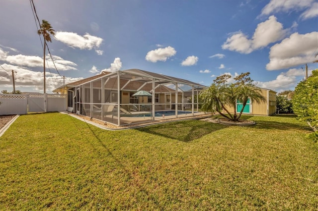 rear view of property featuring a yard and glass enclosure