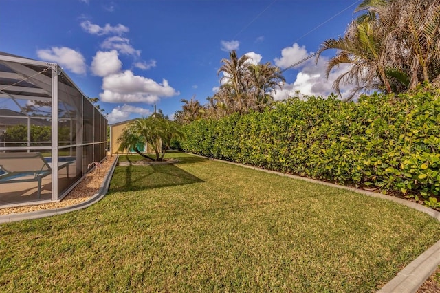 view of yard with glass enclosure