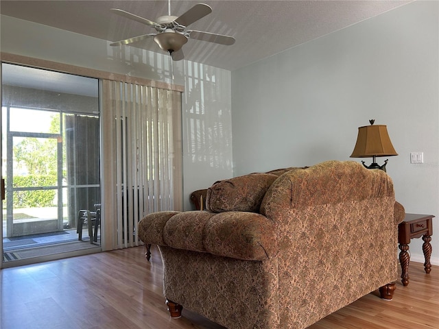 living room featuring hardwood / wood-style flooring and ceiling fan