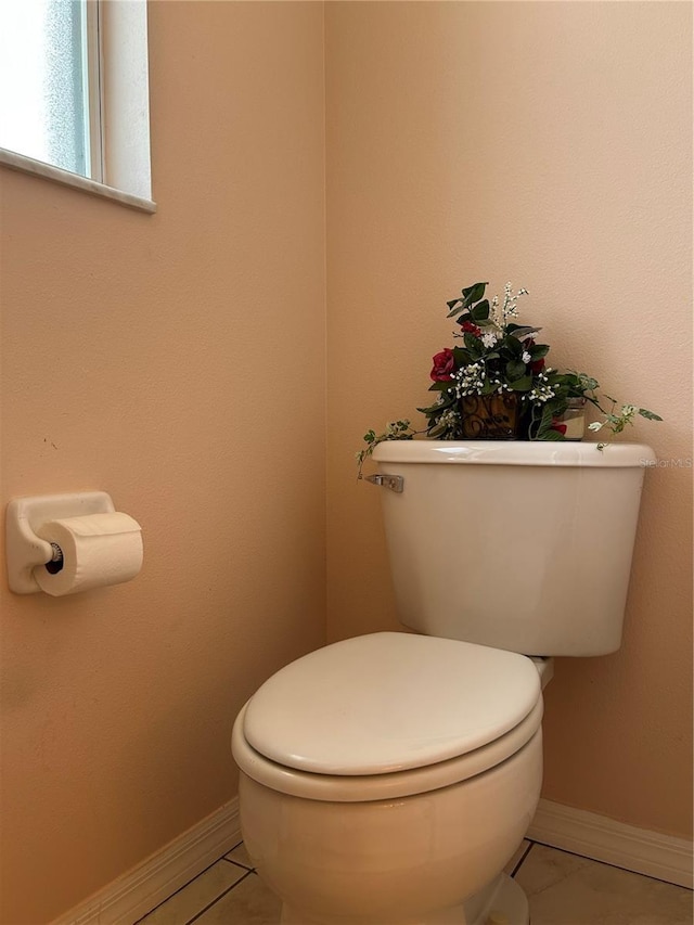 bathroom featuring tile patterned flooring and toilet