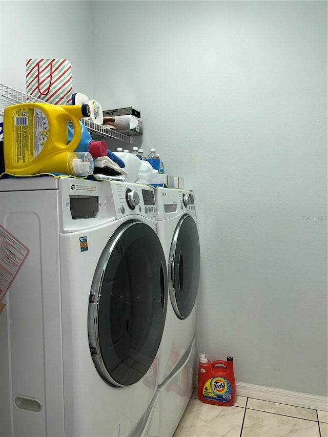 laundry room featuring tile patterned floors and independent washer and dryer