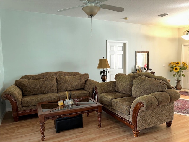 living room featuring light hardwood / wood-style floors and ceiling fan