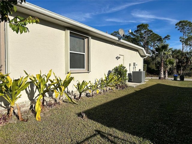 view of home's exterior featuring a yard and central AC unit