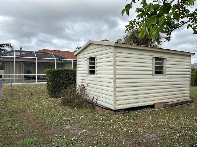 view of property exterior with a lanai and a yard